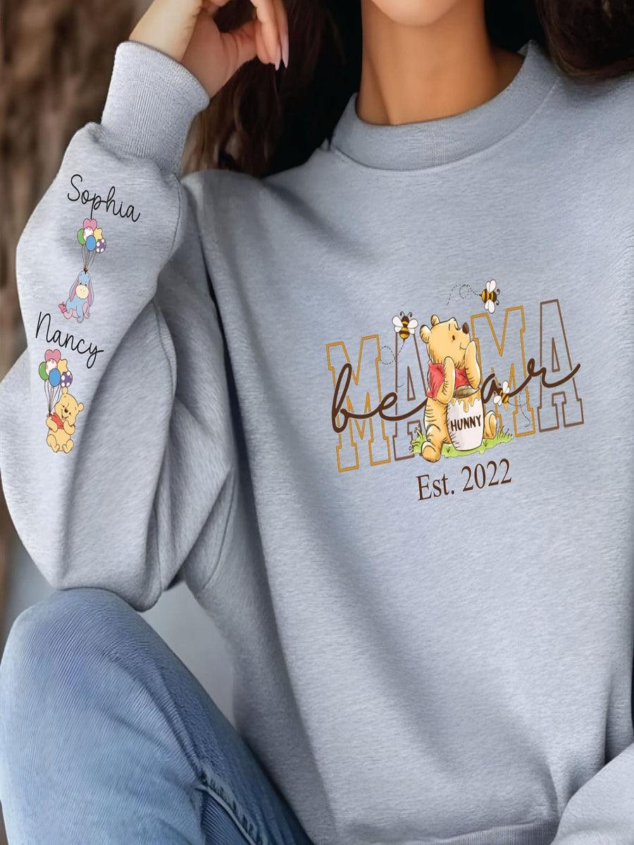 A gray sweatshirt with a Winnie the Pooh-themed design and text printed on it.