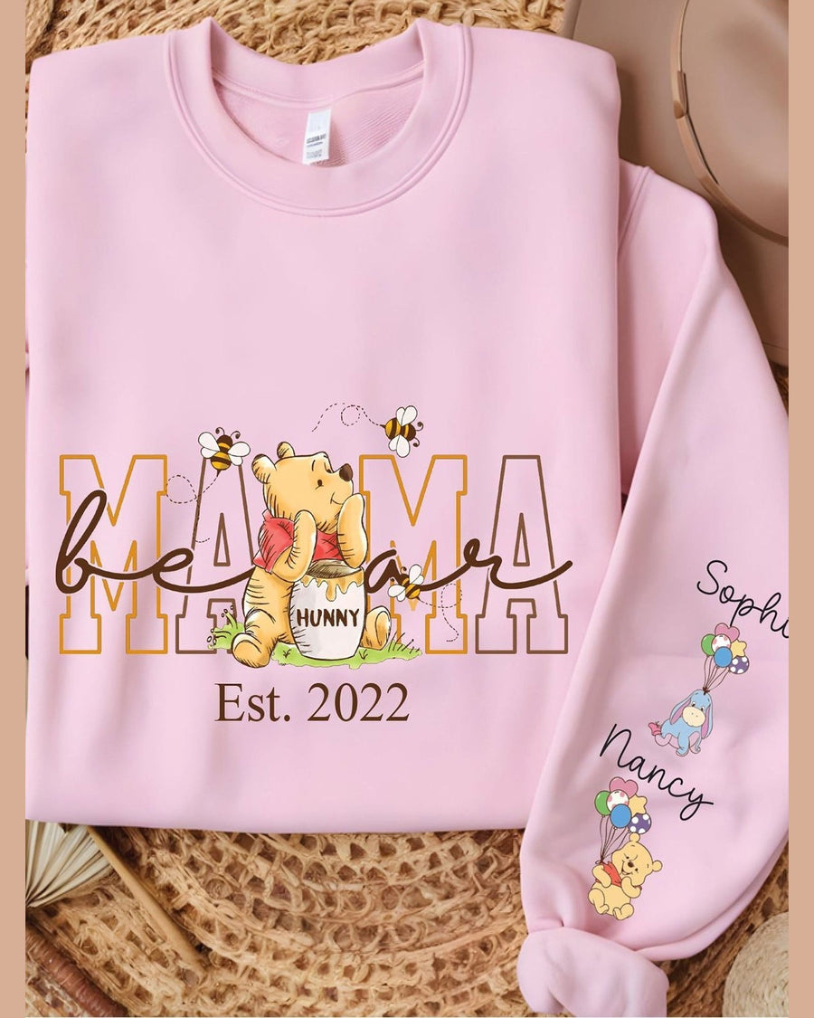 Pink folded Mama crewneck sweatshirt with Winnie the Pooh graphic and rolled sleeve display