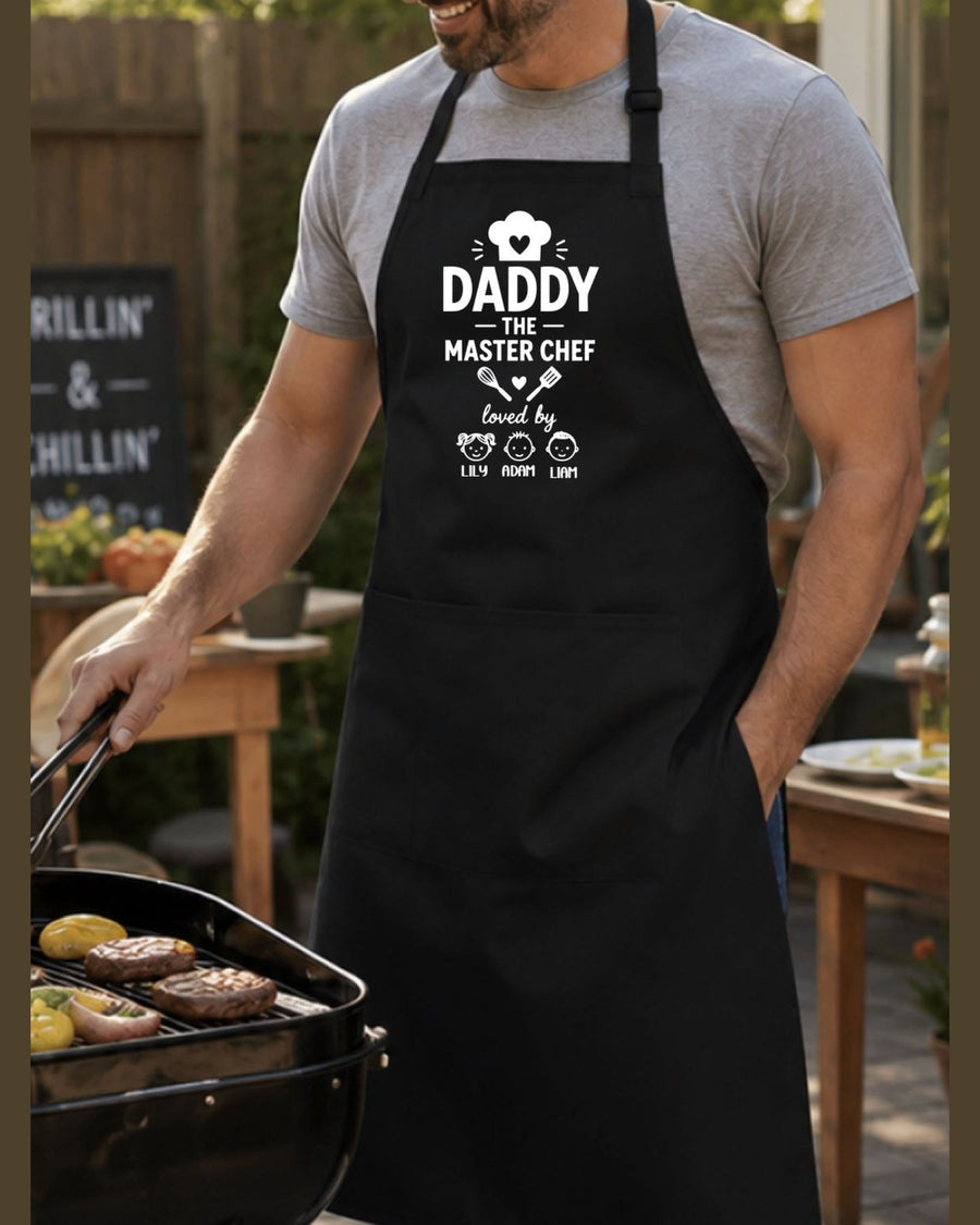 Man wearing custom Daddy Master Chef grill apron while cooking burgers outdoors