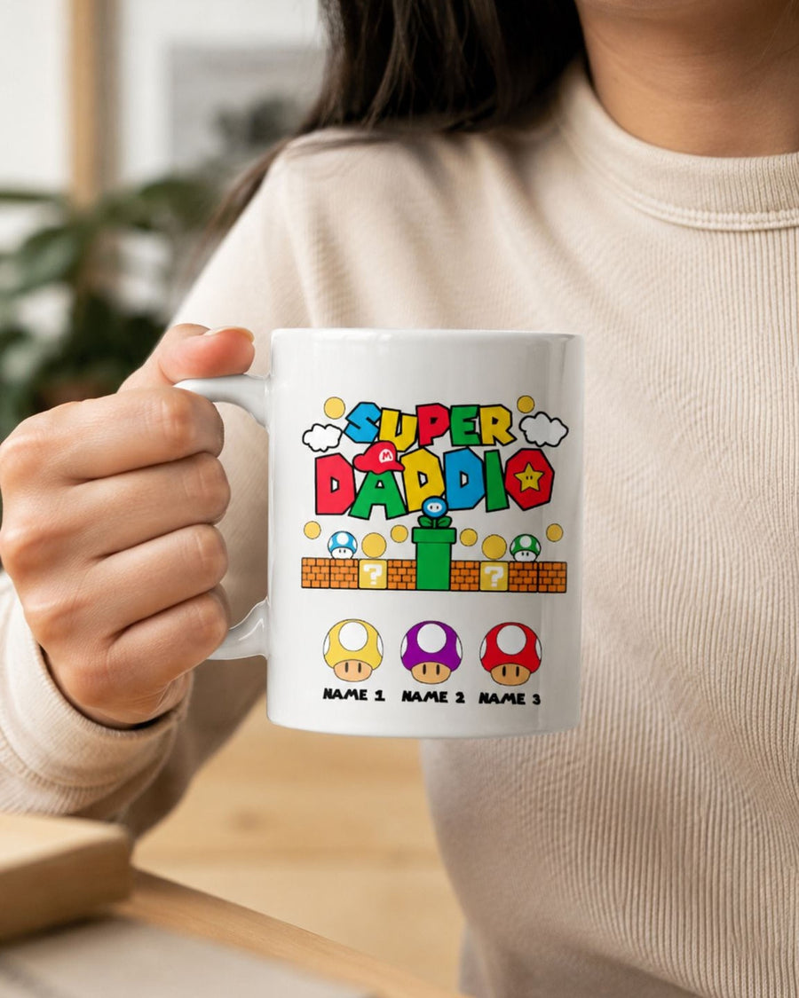 Person holding white Super Daddio retro video game themed personalized coffee mug