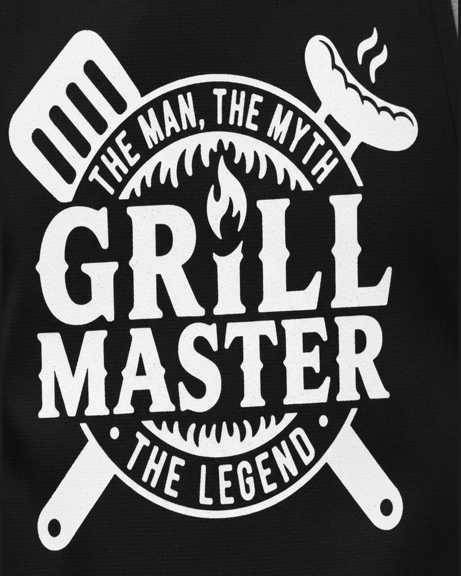 Close-up of black woven BBQ apron fabric showing 'The Man The Myth' Grill Master graphic print