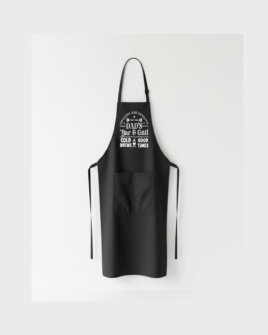 Black Dad's Bar & Grill BBQ apron flat lay with Cold Brews Good Times graphic and front pocket