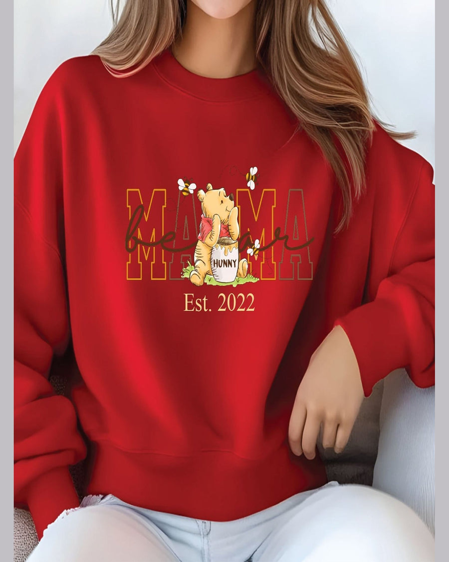 Red Mama crewneck sweatshirt with Winnie the Pooh design and seated lifestyle presentation
