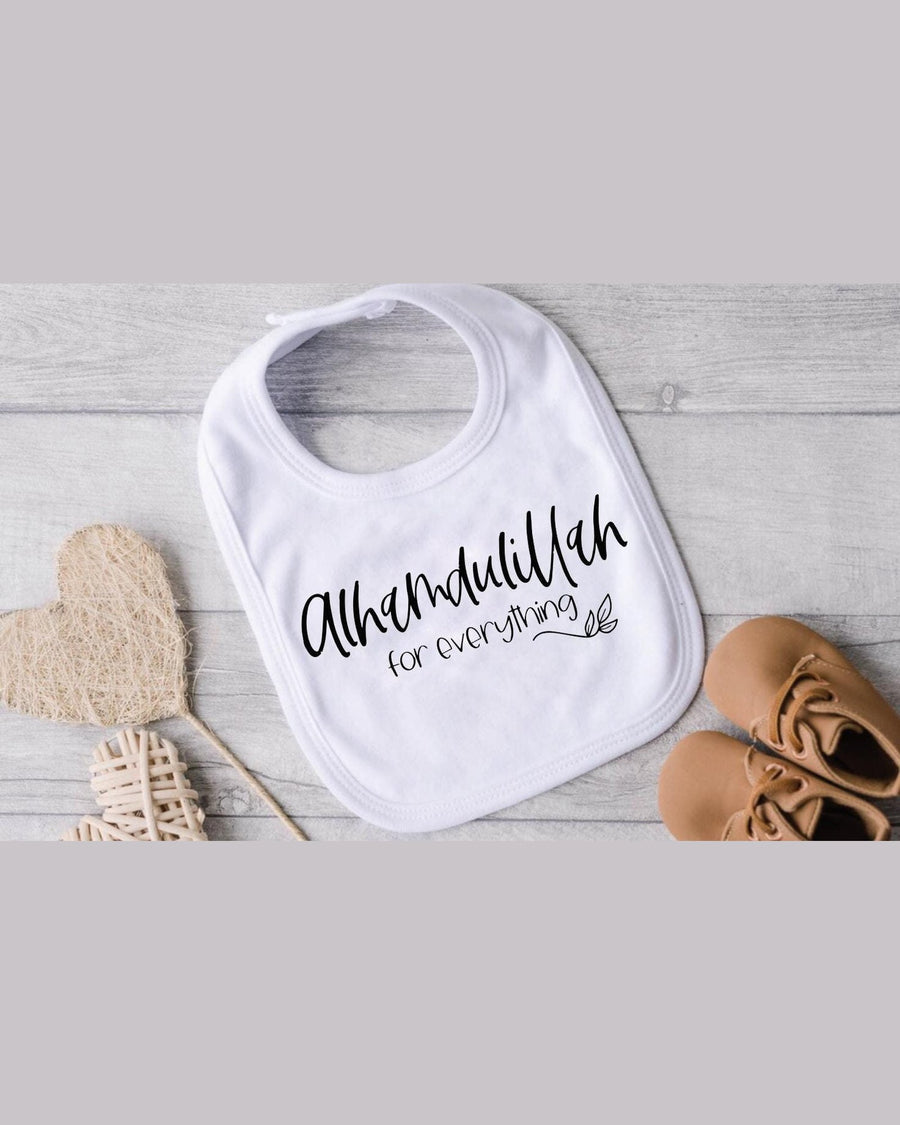 White cotton baby bib with black Alhamdulillah embroidery and leaf flourish