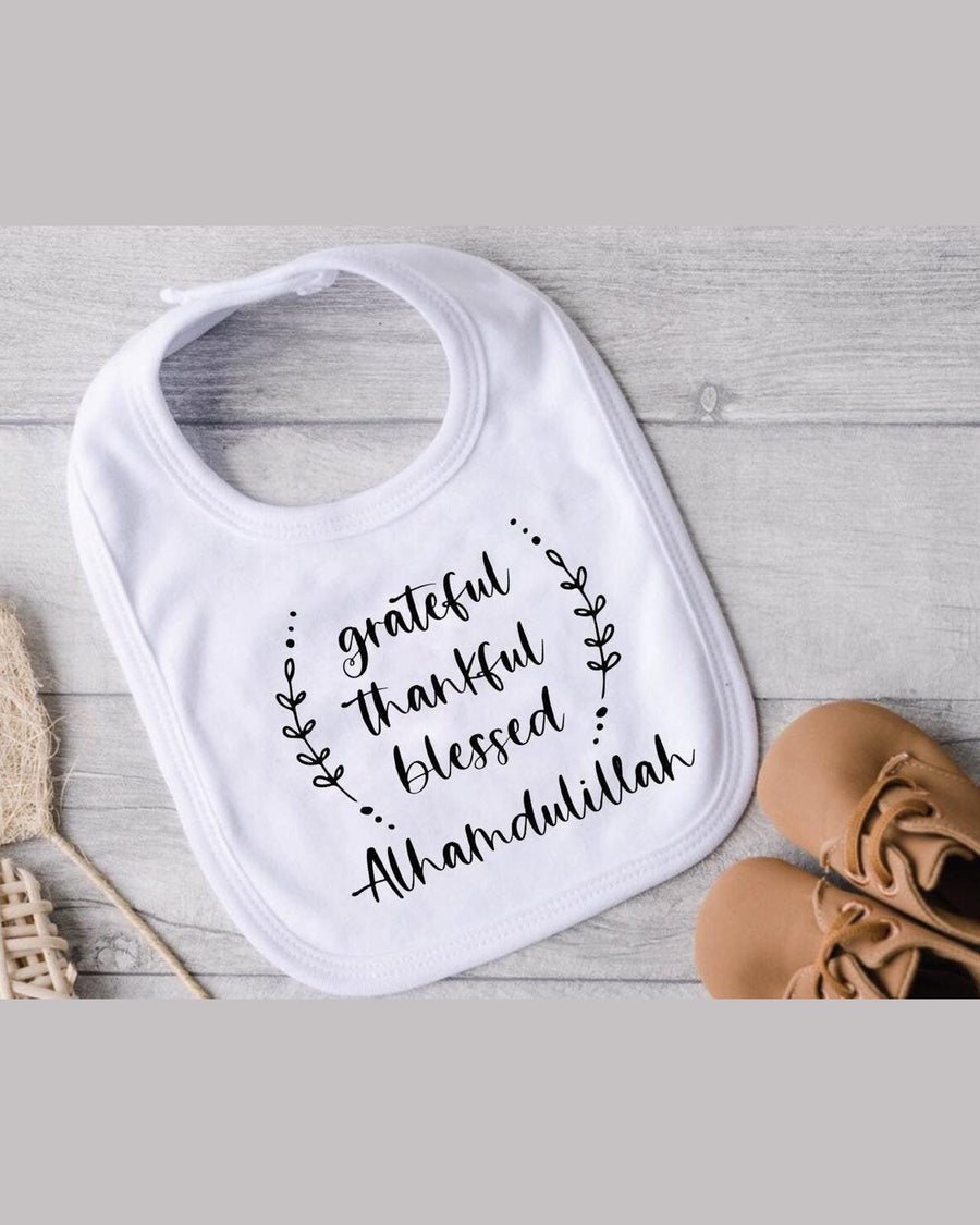 White Alhamdulillah baby bib with grateful thankful blessed text in leafy wreath design