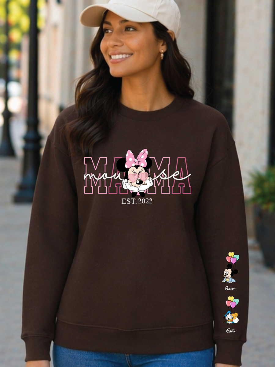 Woman wearing a brown sweatshirt with 'Mama Mouse' design outdoors.