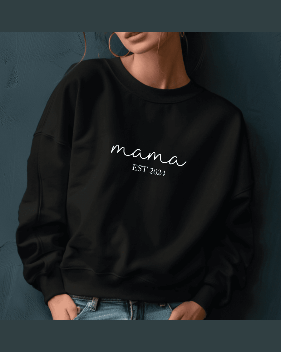 Black custom sweatshirt with ribbed cuffs displaying 'mama EST 2024' in white cursive script