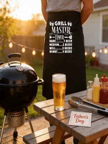 Grill Master Timer apron with funny beer and BBQ graphic design worn by man grilling burgers outdoors.