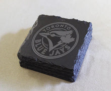 A set of four slate coasters featuring the logo of the Toronto Blue Jays baseball team.