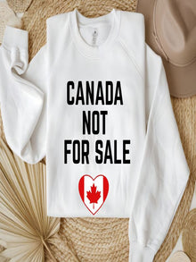 sweatshirt featuring the phrase Canada Not For Sale with a heart-shaped Canadian flag and maple leaf graphic representing Canadian pride.