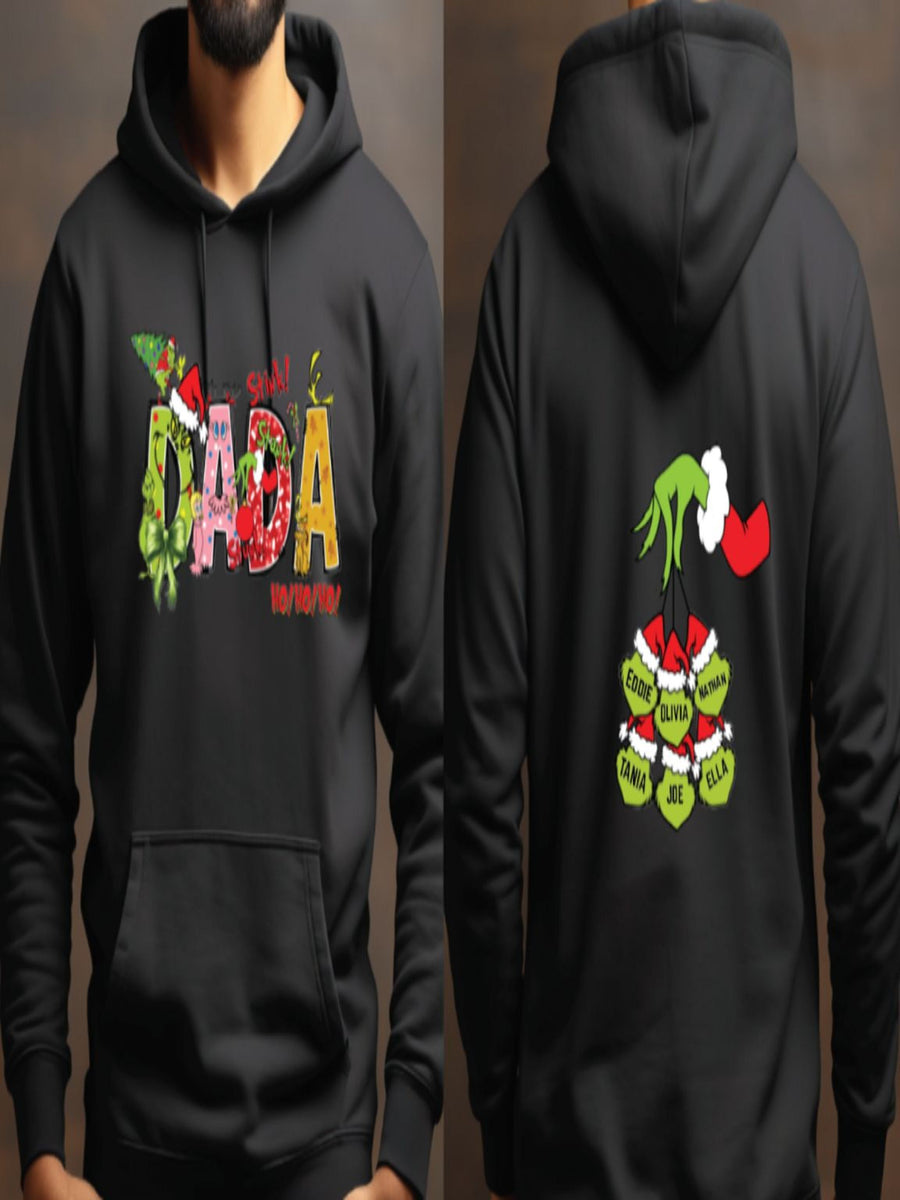A black hoodie with a colorful design featuring the text "Dada" and various holiday-themed graphics, including a Christmas tree, Santa Claus, and other festive elements.