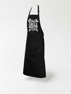 A black apron with white text and graphics on it, including a grill and the text "The Grill Master".