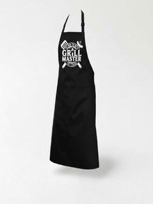 A black apron with white text and graphics on it, including a grill and the text "The Grill Master".