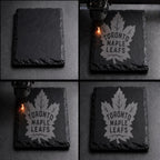 The image is a collage of four photos showing the process of engraving a maple leaf onto a slate or slate-like surface.