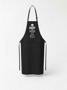 personalized Daddy The Master Chef BBQ apron with custom kids names worn by dad grilling outdoors.