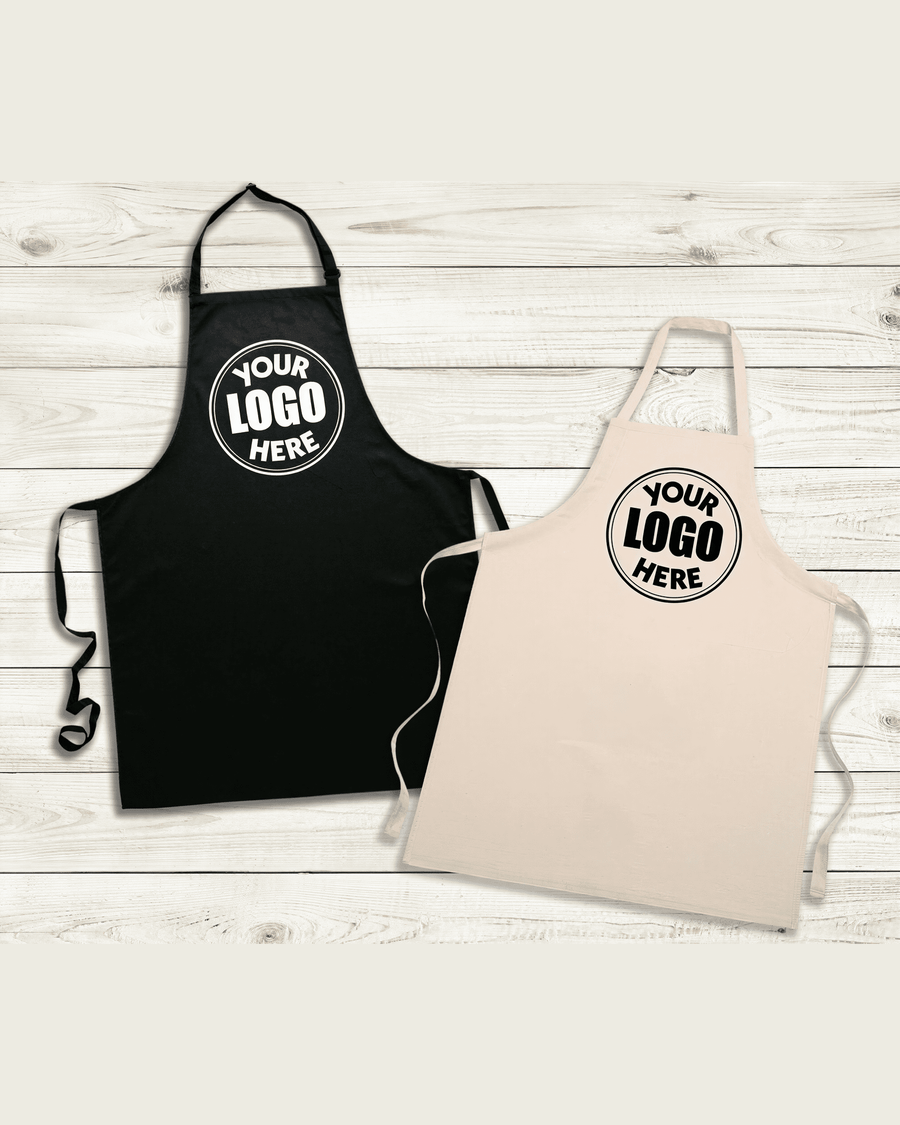 two aprons with the same logo printed on them, placed on a wooden surface.