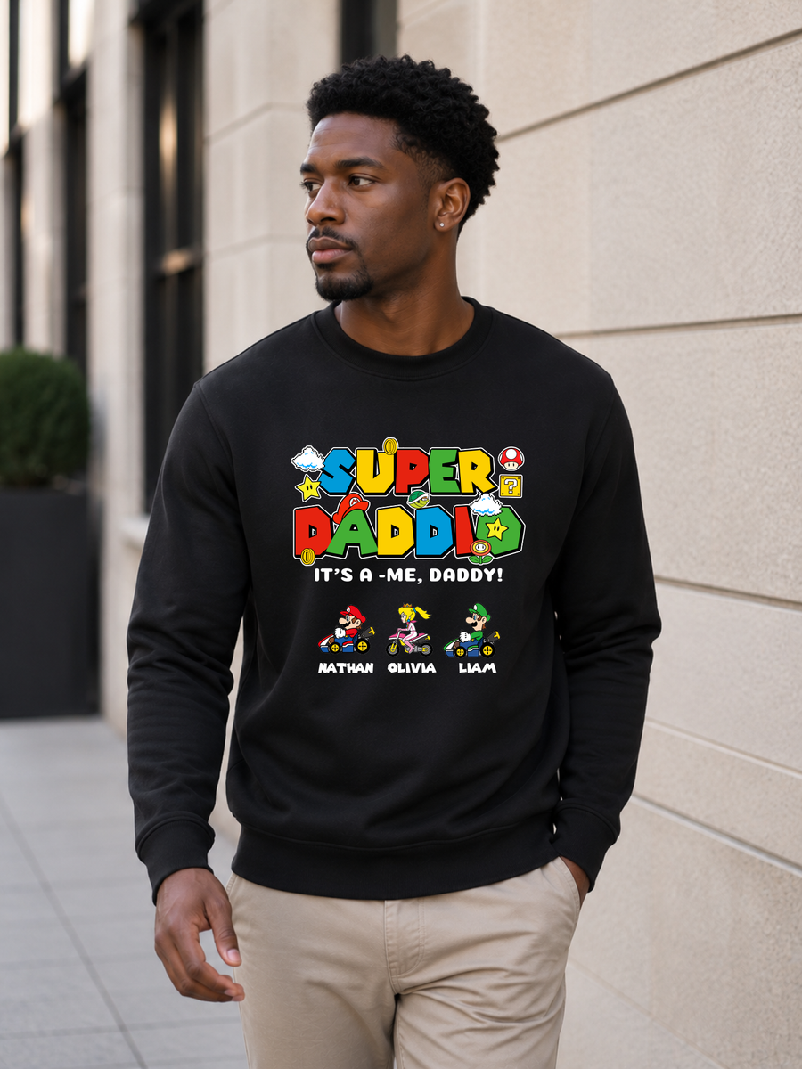 Super Daddio personalized sweatshirt featuring retro gamer-inspired colorful artwork and custom kids names worn by male model outdoors.
