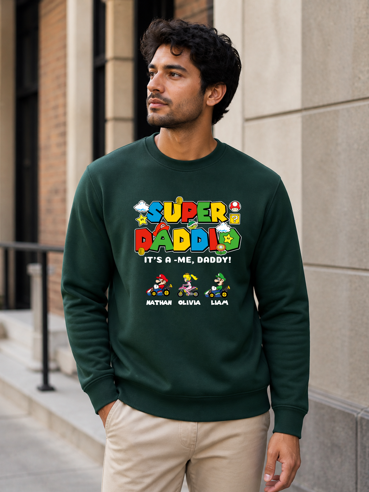 Super Daddio personalized sweatshirt featuring retro gamer-inspired colorful artwork and custom kids names worn by male model outdoors.