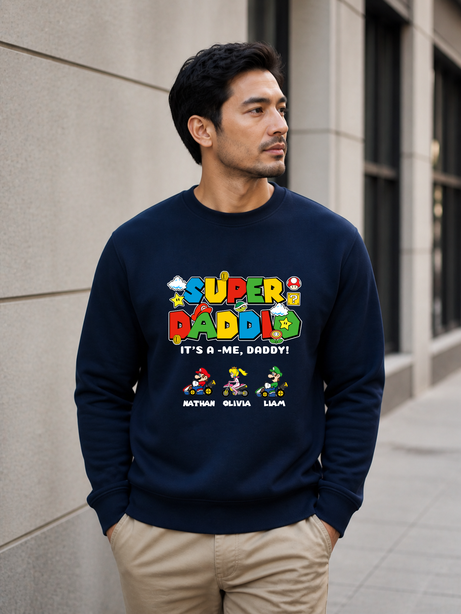 Super Daddio personalized sweatshirt featuring retro gamer-inspired colorful artwork and custom kids names worn by male model outdoors.