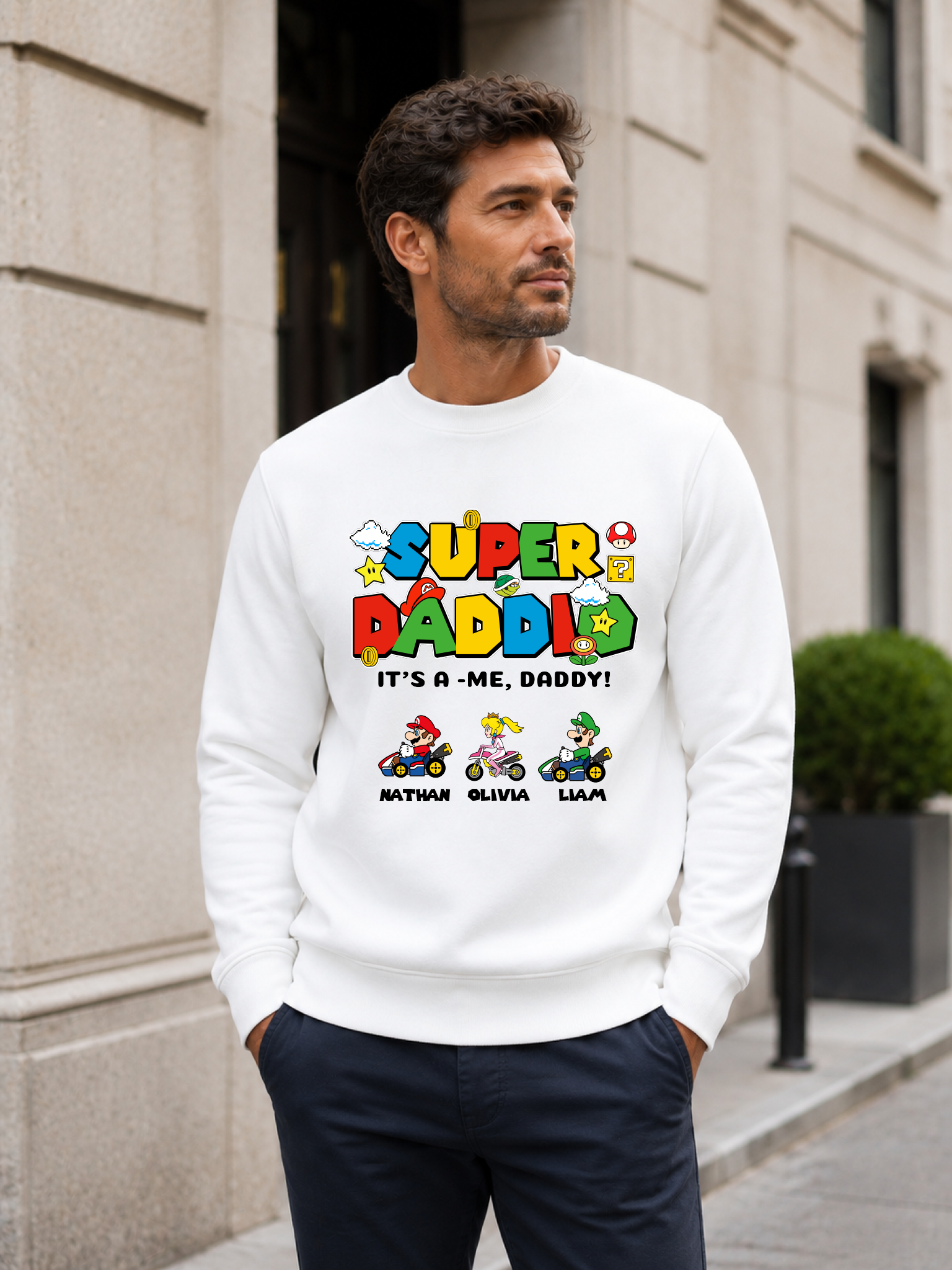 Super Daddio personalized sweatshirt featuring retro gamer-inspired colorful artwork and custom kids names worn by male model outdoors.