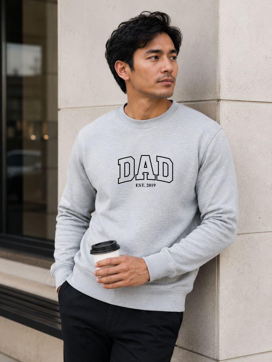 Man wearing a black sweatshirt with 'DAD EST. 2019' text