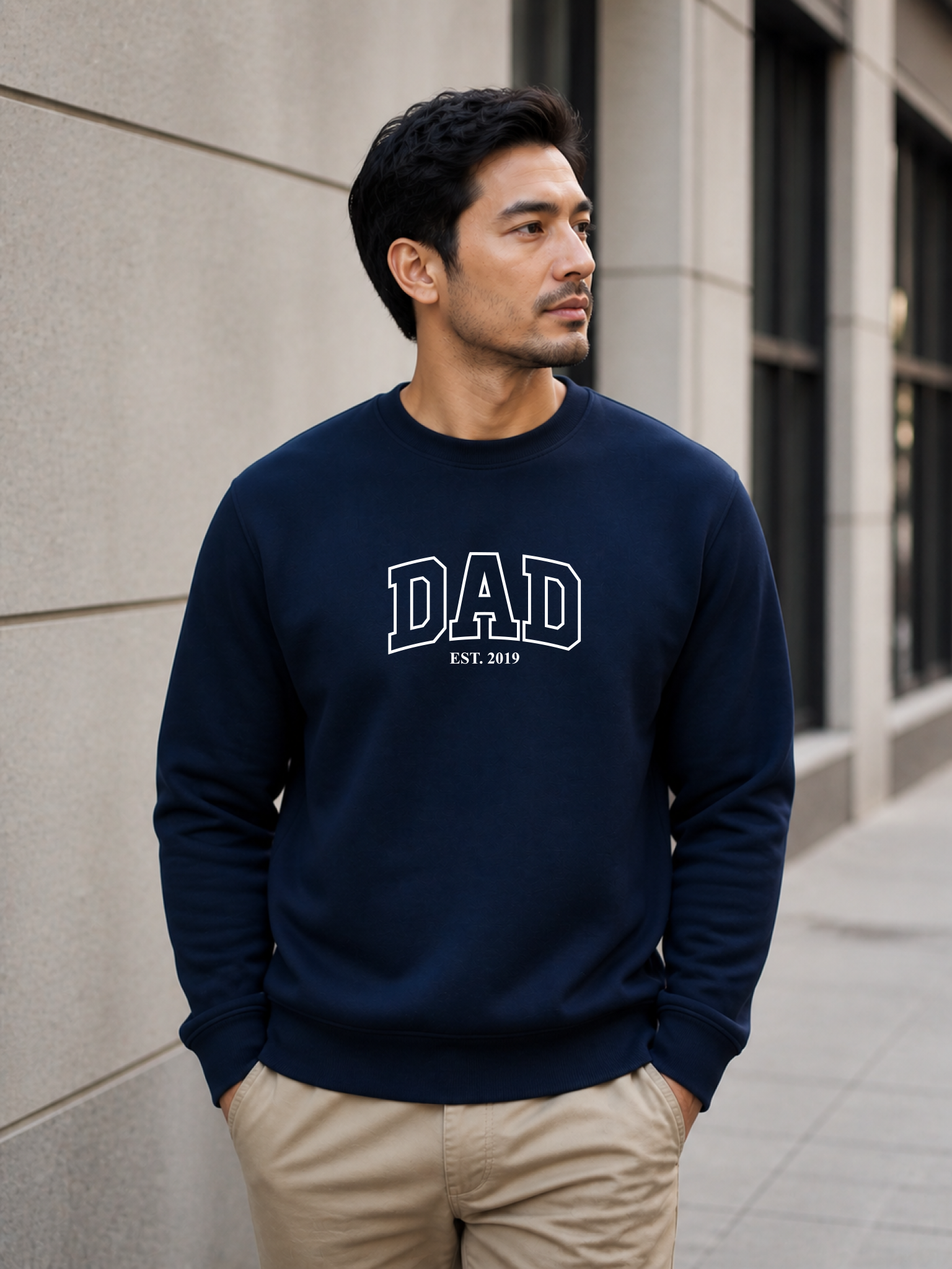 Man wearing a black sweatshirt with 'DAD EST. 2019' text