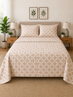 Bedroom with a bed featuring a patterned comforter, nightstands, and wall art.
