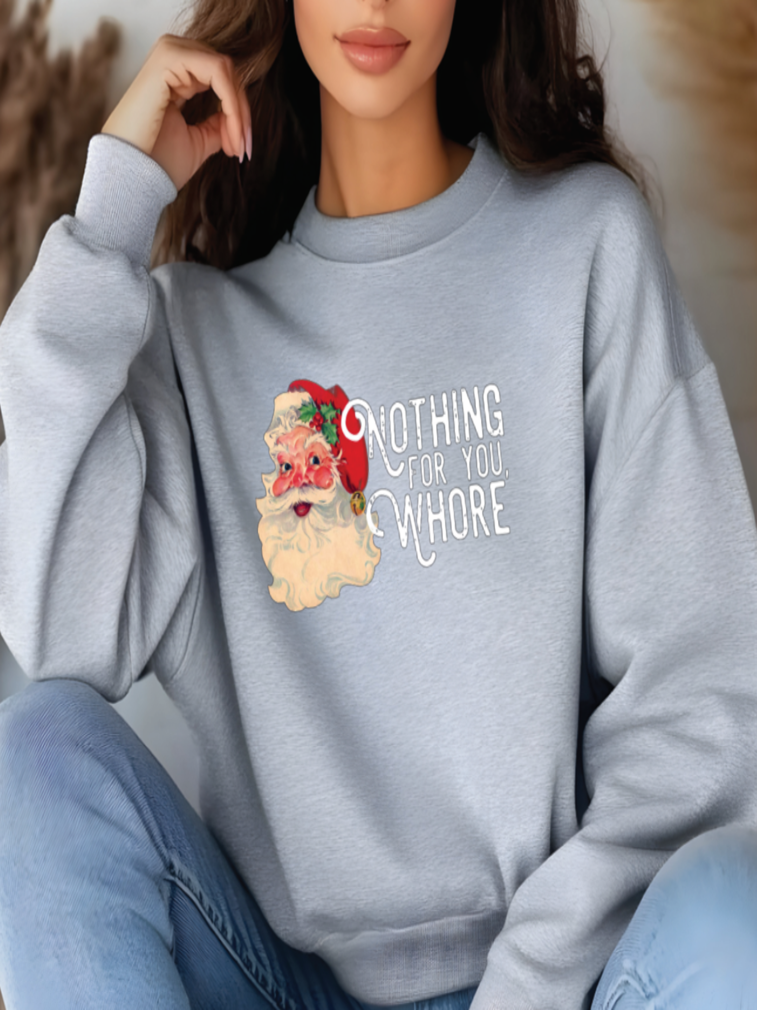 Person wearing a light gray sweatshirt with a graphic design and text.