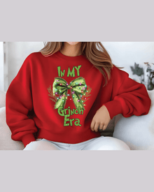 Red custom Christmas hoodie with Grinch Era bow graphic for festive casual wear