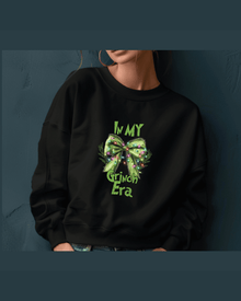 Black custom name hoodie featuring green glitter Grinch Era text and bow design