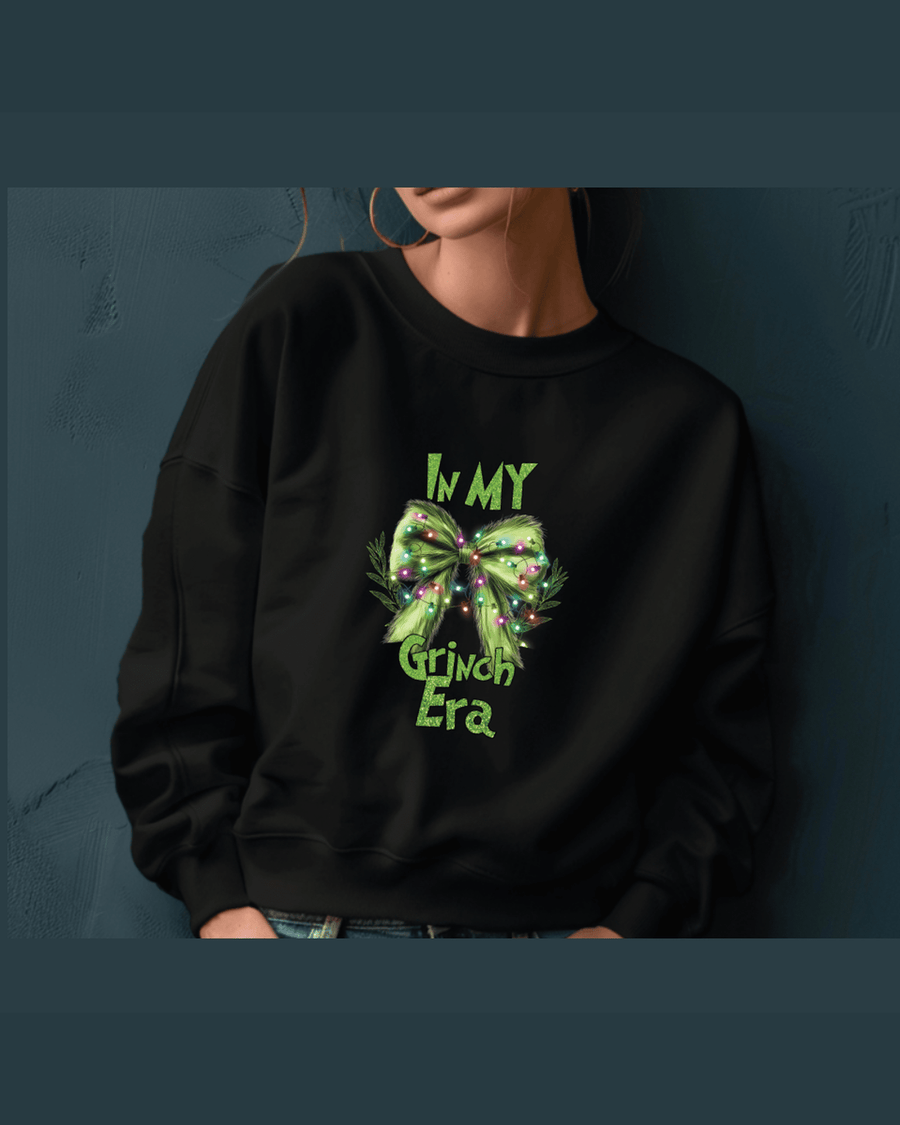 Black custom name hoodie featuring green glitter Grinch Era text and bow design