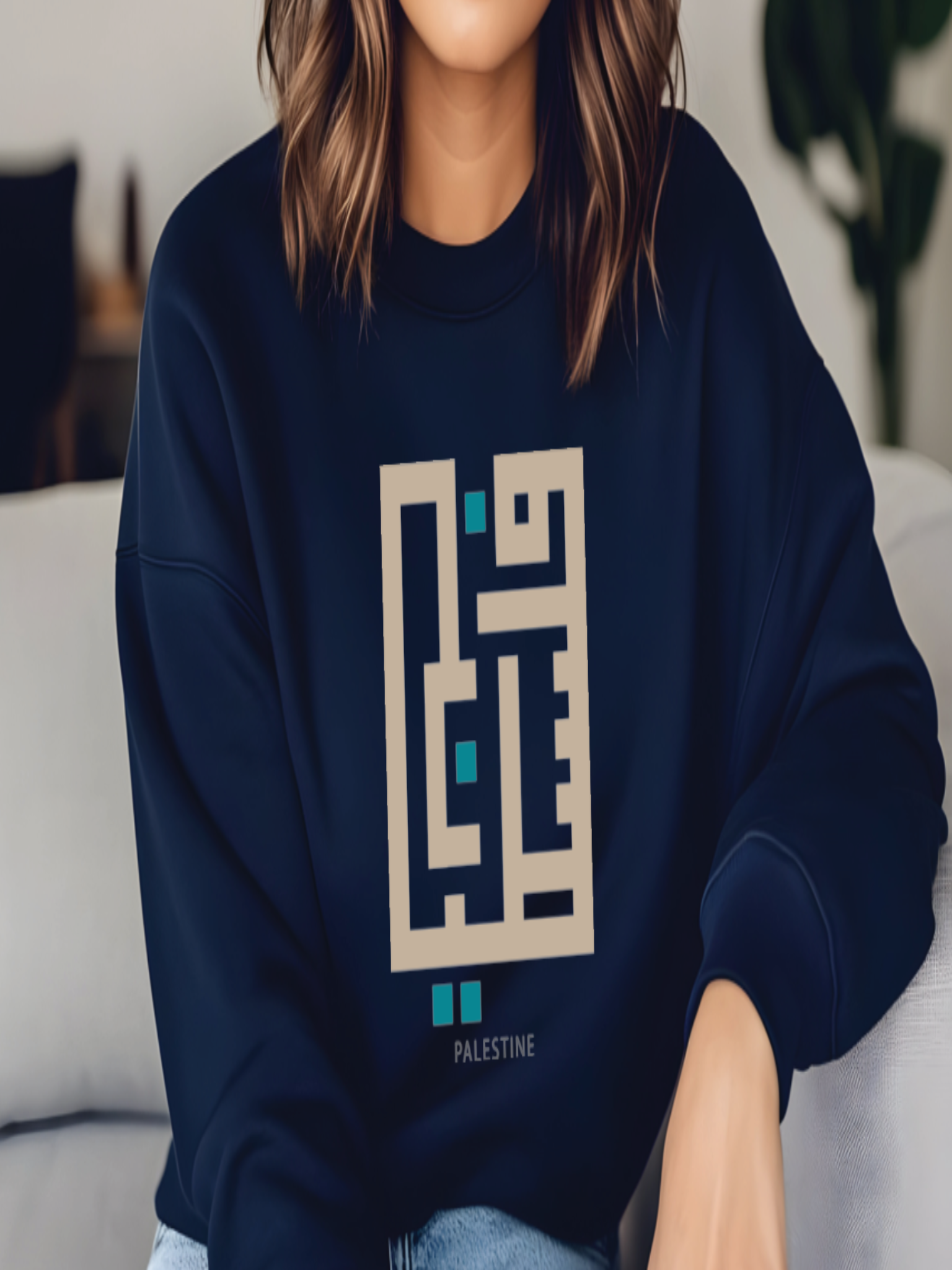 Person wearing a navy blue sweatshirt with a geometric design and 'Palestine' text.
