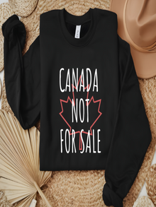 sweatshirt featuring the phrase Canada Not For Sale over a red maple leaf outline in a minimalist Canadian pride design.