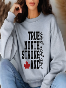 sweatshirt featuring the phrase True North Strong and Free with a red maple leaf graphic in a bold Canadian pride design.