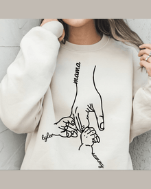 Beige custom sweatshirt with black line art of three hands holding labeled Mama, Tyler, and Sammy