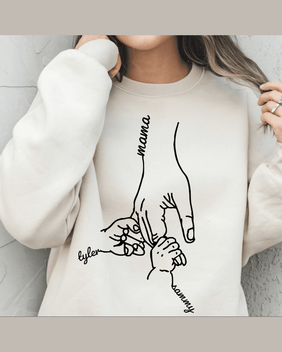 Beige custom sweatshirt with black line art of three hands holding labeled Mama, Tyler, and Sammy