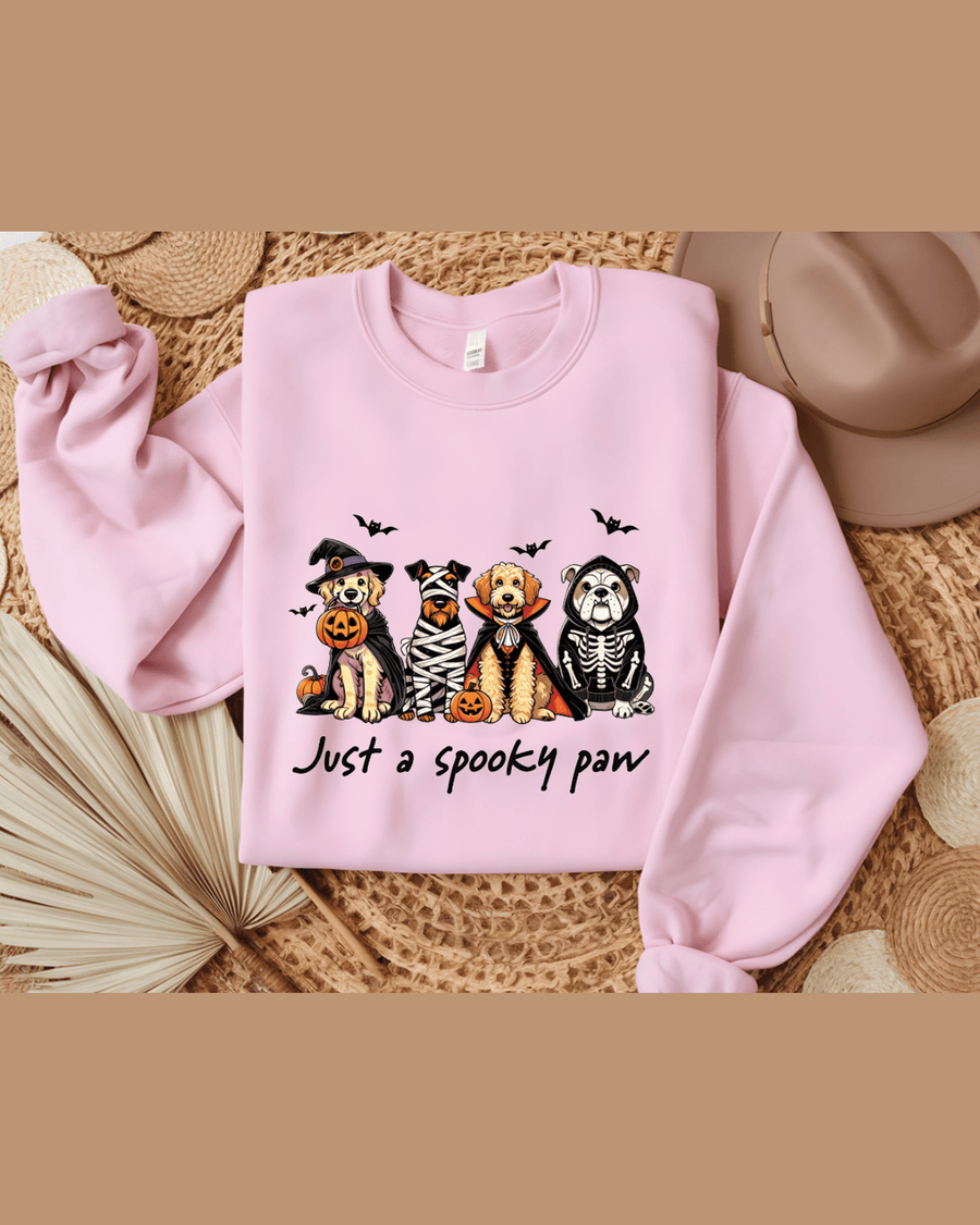 Pink personalized hoodie flat lay showing Halloween dog print, ribbed cuffs, and care tag
