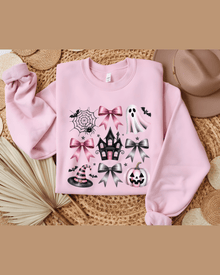 Pink crewneck custom name hoodie with Halloween graphics laid flat