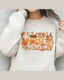 Cream unisex fit hoodie featuring cozy autumn drink graphics and It's Fall Yall text