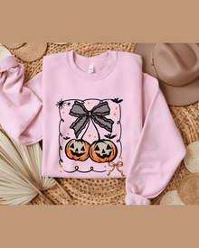 Pink custom graphic hoodie with Halloween jack-o'-lanterns and lace bow design