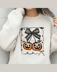 Cream personalized sweatshirt featuring Halloween pumpkin graphic and lace bow