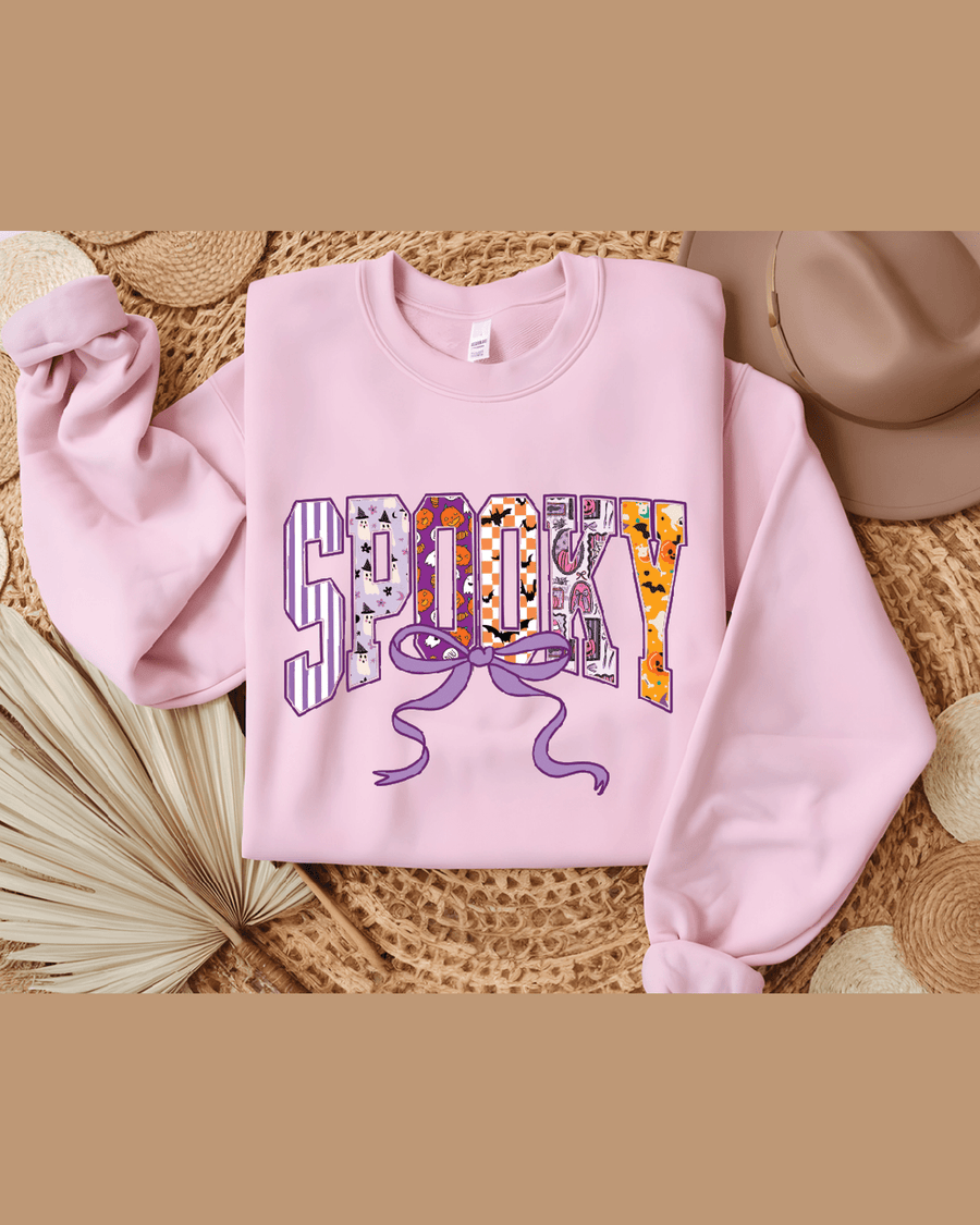 Pink custom name hoodie laid flat showing Spooky graphic print detail