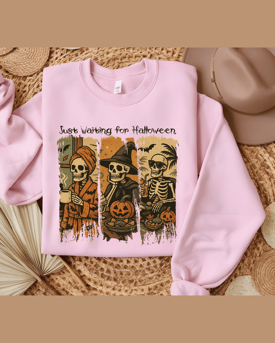 Pink custom Halloween hoodie with triptych skeleton graphic and 'Just Waiting for Halloween' text