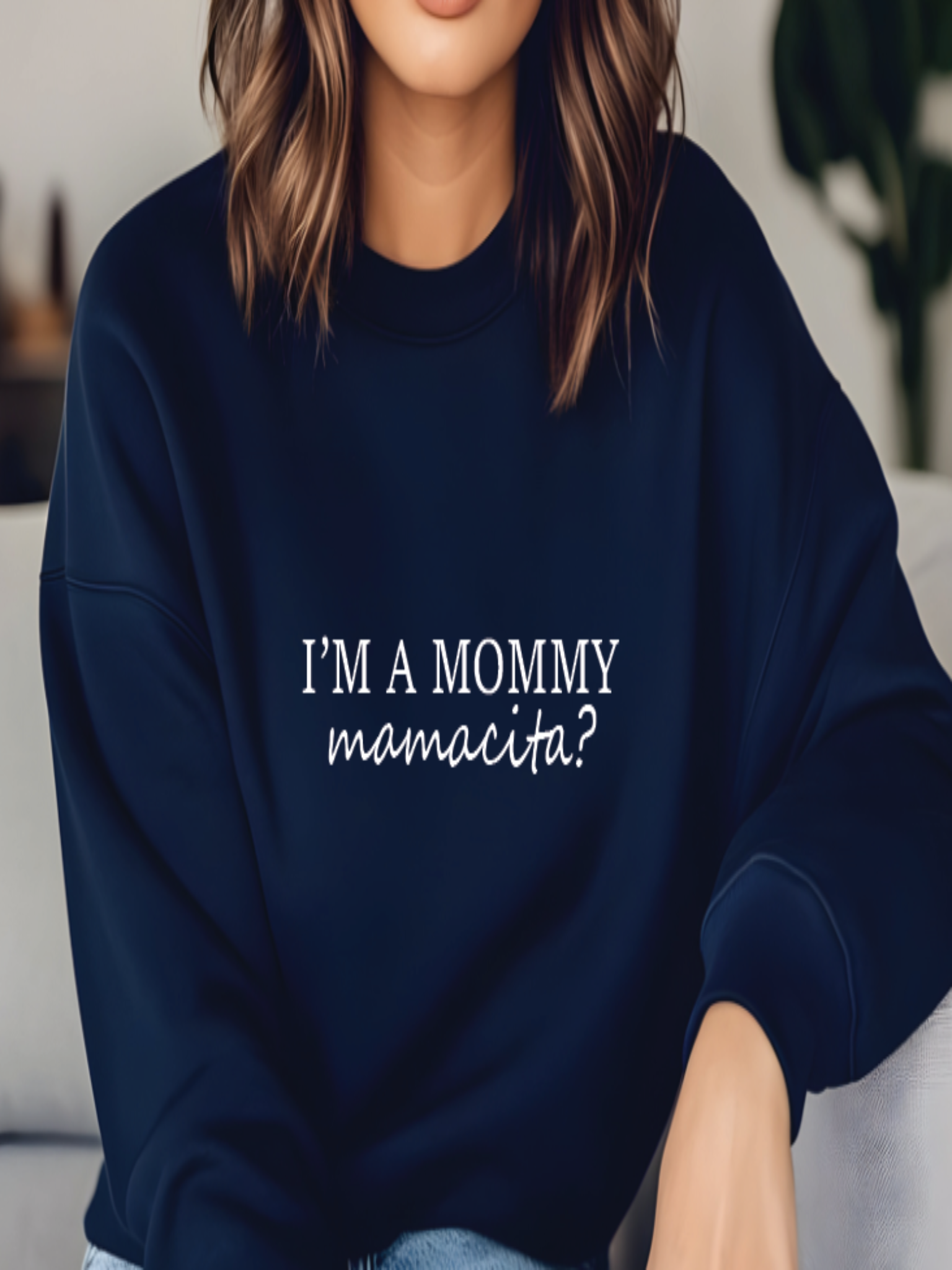 Person wearing a navy blue sweatshirt with text in a casual setting