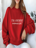 Person wearing a red sweatshirt with text sitting on a couch.