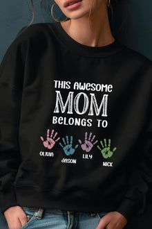 A woman wearing a black sweatshirt with a personalized message printed on it.