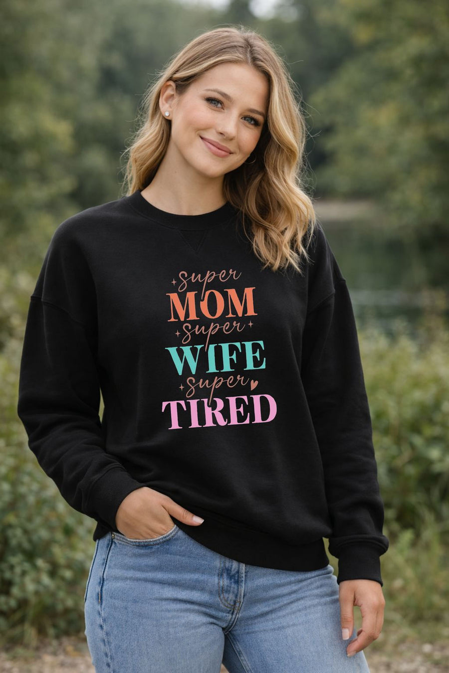 A smiling woman wearing Mom Wife Tired sweatshirt – cozy mom crewneck gift for Mother’s Day Canada