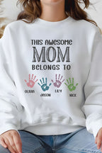 A person wearing a white sweatshirt with text and handprints printed on it.