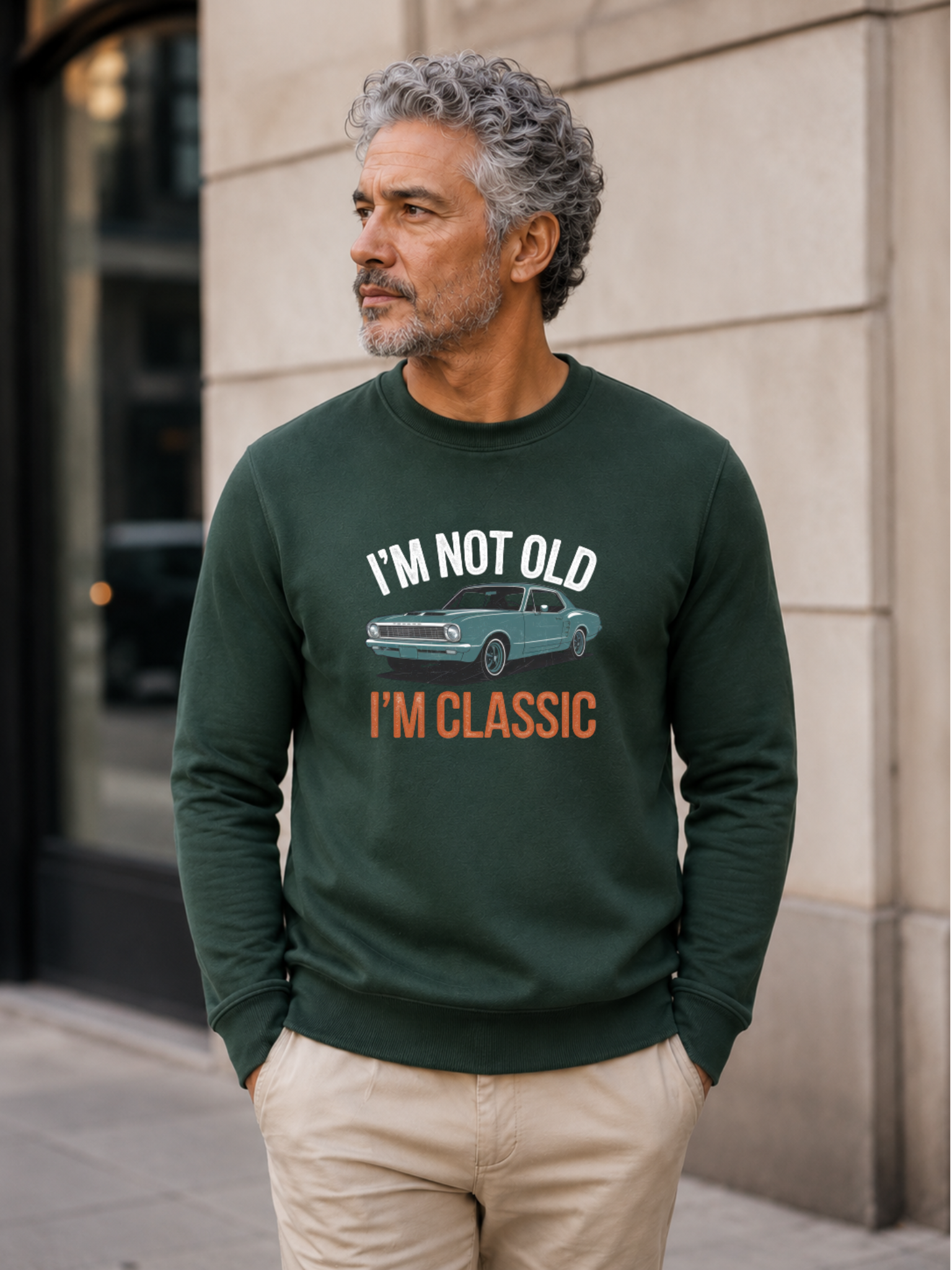 I'm Not Old I'm Classic sweatshirt featuring a vintage muscle car graphic and funny retro slogan worn by male model outdoors.
