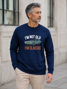 I'm Not Old I'm Classic sweatshirt featuring a vintage muscle car graphic and funny retro slogan worn by male model outdoors.